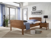 Einzelbett aus Holz mit Komforthöhe